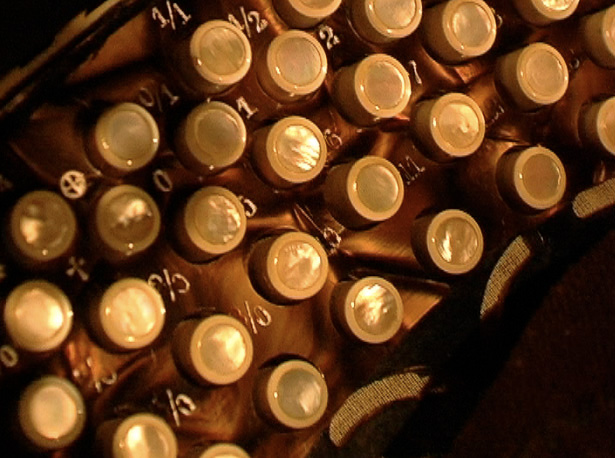 close-up  of right hand keyboard showing its mother of pearl finished  buttons